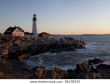 Fort Williams lighthouse in South Portland Maine in late March at sunrise