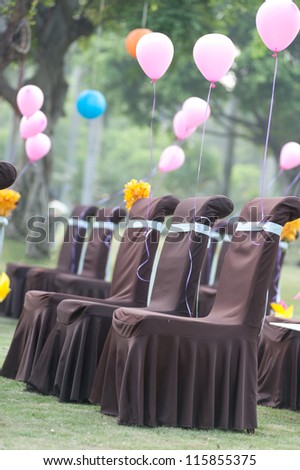 Chairs and balloons for wedding on the lawn