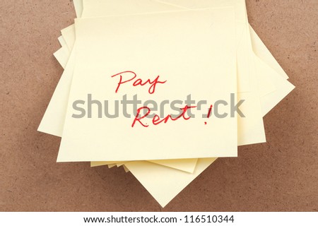 Pay rent words written on sticky note