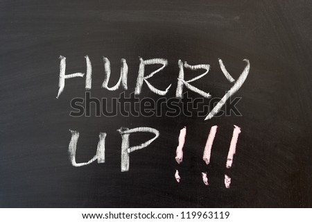Hurry up words written on the chalkboard