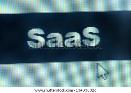 Cloud computing concept - SaaS word and cursor on computer monitor