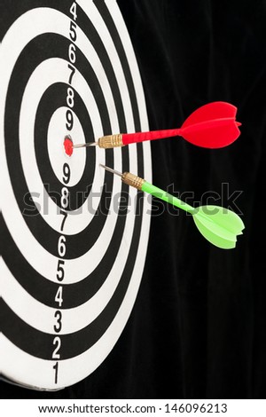 Two darts pinned on the dart board with rings group