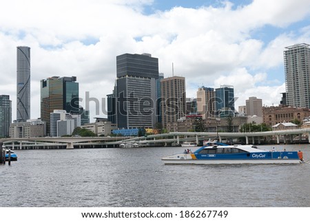 BRISBANE, AUSTRALIA - JAN 29, 2014: A stylish vessel moves on Brisbane River with modern buildings on the background