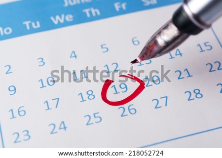 Red circle marked on a calendar with a pen