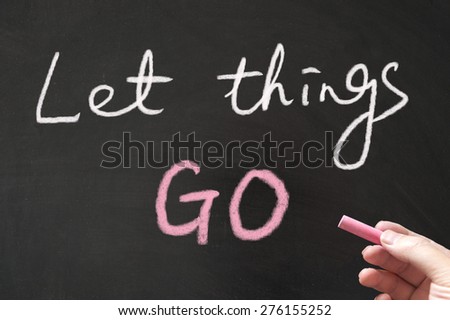 Let things go words written on blackboard using chalk