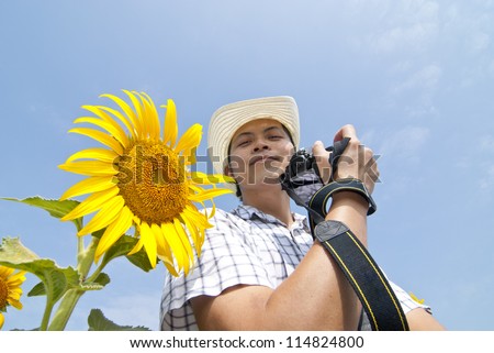 Portrait Cowboy man with sunflower and Blue sky