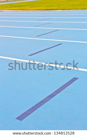 Blue running track in sport stadium