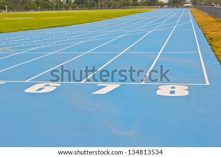 Blue running track in sport stadium