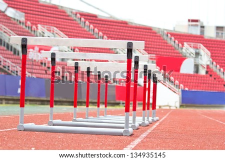 hurdles on the red running track prepared for competition.