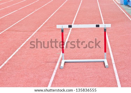 hurdles on the red running track prepared for competition.