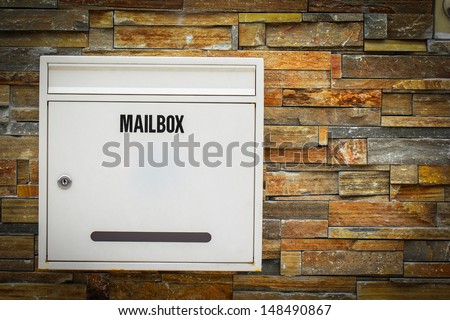 White mail box hang on the rock background