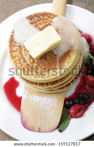 Mixed berry pancakes on the white dish