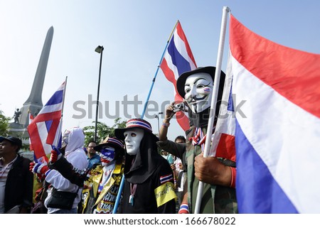 BANGKOK - DEC 9: Many Masked protesters walked for anti government corruption on December  09, 2013 in Bangkok, Thailand. The protesters required  Yingluck Shinawatra Prime Minister resign.
