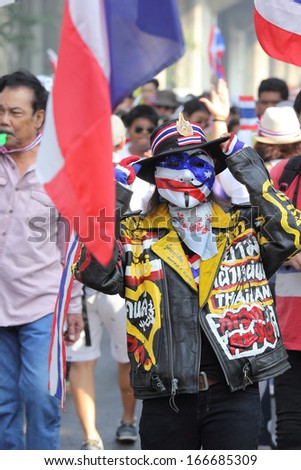 BANGKOK - DEC 9: Many Masked protesters walked for anti government corruption on December  09, 2013 in Bangkok, Thailand. The protesters required  Yingluck Shinawatra Prime Minister resign.