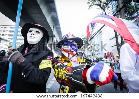 BANGKOK - DEC 9: Many Masked protesters walked for anti government corruption on December 09, 2013 in Bangkok, Thailand. The protesters required Yingluck Shinawatra Prime Minister resign.