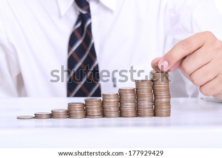 Businessmen put coin stack money for money growth concept