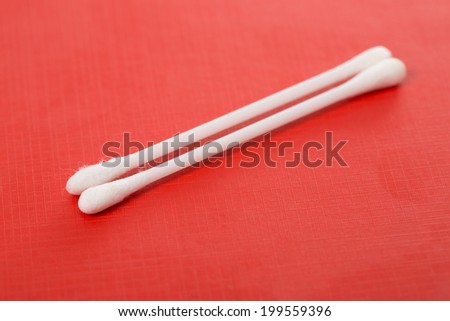 White Cotton buds in red background
