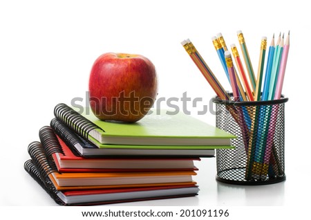 Apple on top colorful books isolated with white background