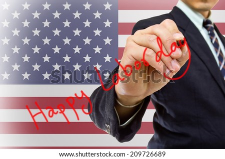 Businessman hand write Happy labor day with USA Flag