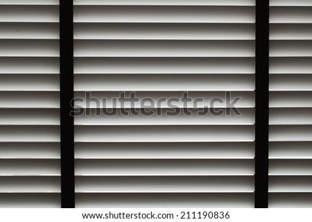 Venetian blinds in home catching sunlight