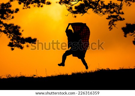 Young man run and hold Fabric for joy his freedom in the nature