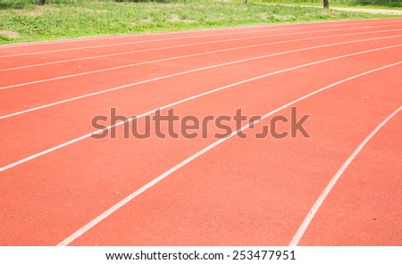 Red color running track in football stadium