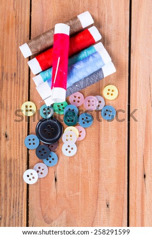 Yarn scissors ,measuring tape and Yarn Sewing with wood background
