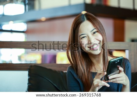 Young Asian women use smart phone for call and massage to her friend.