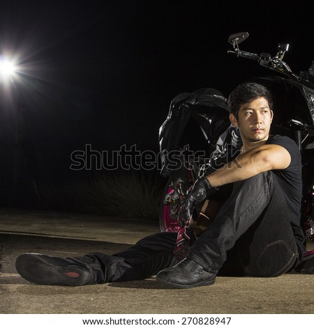Motorcycle rider sit for relax with black background