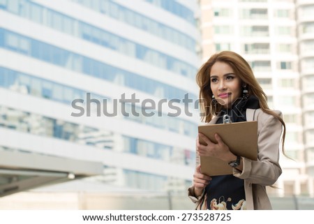 Businesswoman note and think her job with wood board.
