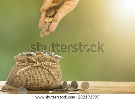 Save money concept with put money coin to bag in the morning.