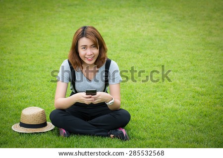 Young Asian women use smart phone for call and massage to her friend.