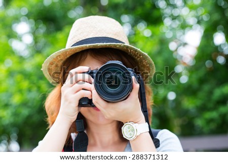 Young girl Photographer holding vintage camera with white background.
