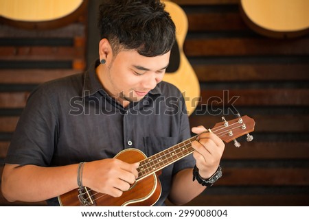 Ukulele Guitar teacher teach music in school