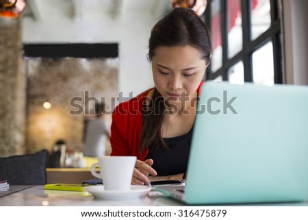 Lifestyle coffee ,woman using smartphone for search information in cafe shop.