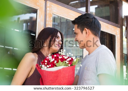 Couple in love ,man holding bouquet rose to give yoru girlfriend.