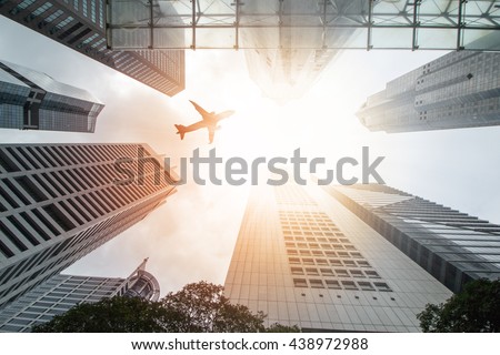 Airplane flight over city building for transportation passengers ,fly travel