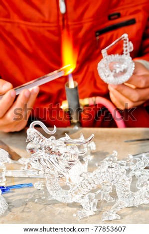 Burning glass for do dragon glass doll Hands of the handicraftsman making a glass subject
