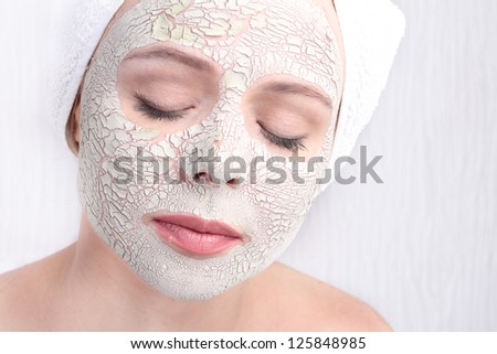 Beautiful Woman With Cosmetic Clay Mask on Face face.