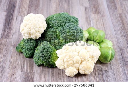 Brussels sprouts, broccoli and cauliflower, fresh vegetables on wooden background