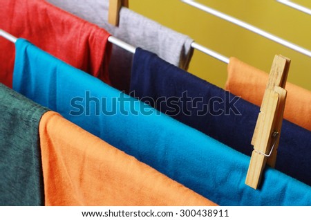 Drying colorful clothes hanged on the clothes horse