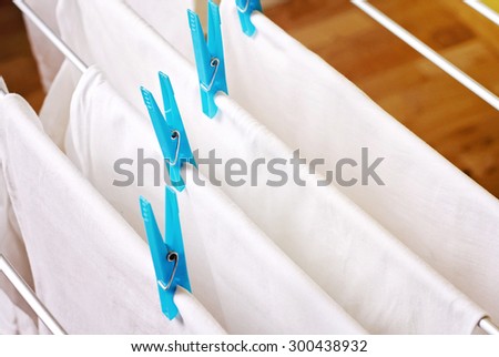 Clean white laundry pinned with blue clothespins
