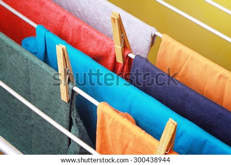 Drying colorful clothes hanged on the clothes horse