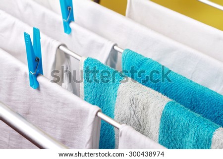 Clean white laundry pinned with blue clothespins
