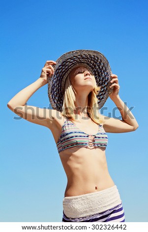 Young women in straw hat enjoying the sun