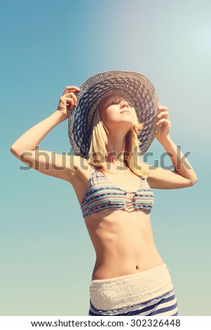 Young women in straw hat enjoying the sun