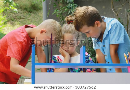 Stylish kids playing school. Outdoor photo. Education and kids fashion concept