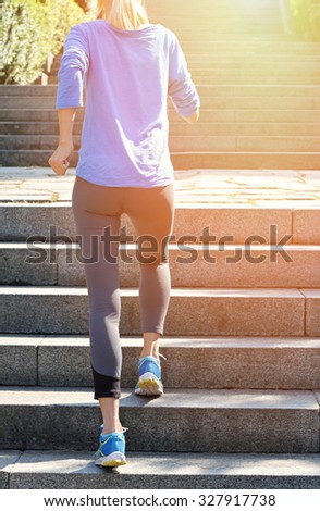 Female athlete running on stairs. Running, jogging, sport, fitness, active lifestyle concept