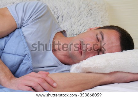 Sleeping man: Young handsome man sleeping in bed