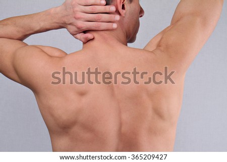 Male Waxing. Muscular male torso, chest and armpit hair removal close up.